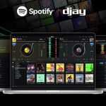 Screen displaying the djay software with Spotify integration, showcasing a music mixing interface and album artwork, ideal for Michigan web design projects focusing on music and entertainment.